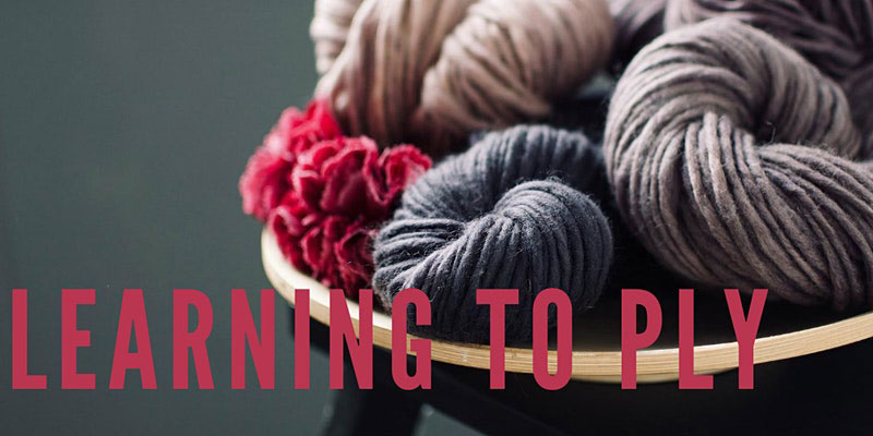 Image with text. Text reads "learning to ply" Image shows balls of wool.